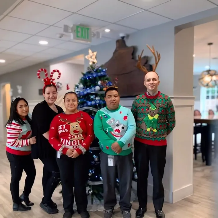 William Horschak with his team in holiday sweaters at a Half Moon Bay community